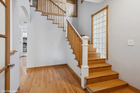 a view of entryway and hall with wooden floor