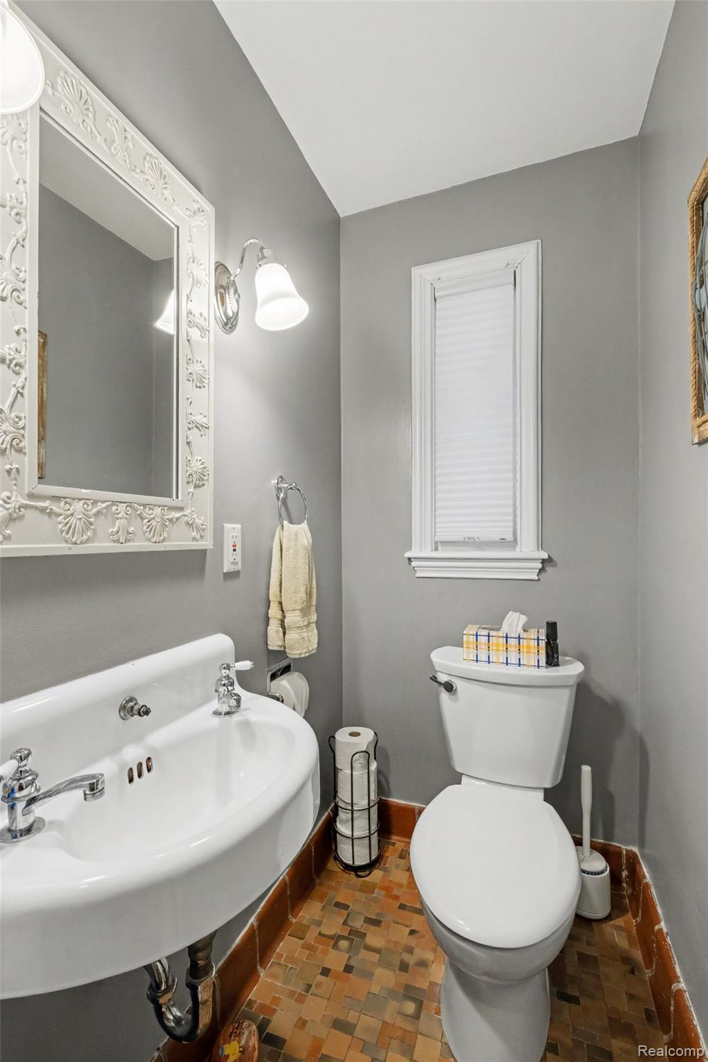 2030 Hampden Road Flint, MI 48503 - Photo 22 of 34 Pedestal sink with chrome fixtures, distressed tile flooring, and a window with blinds