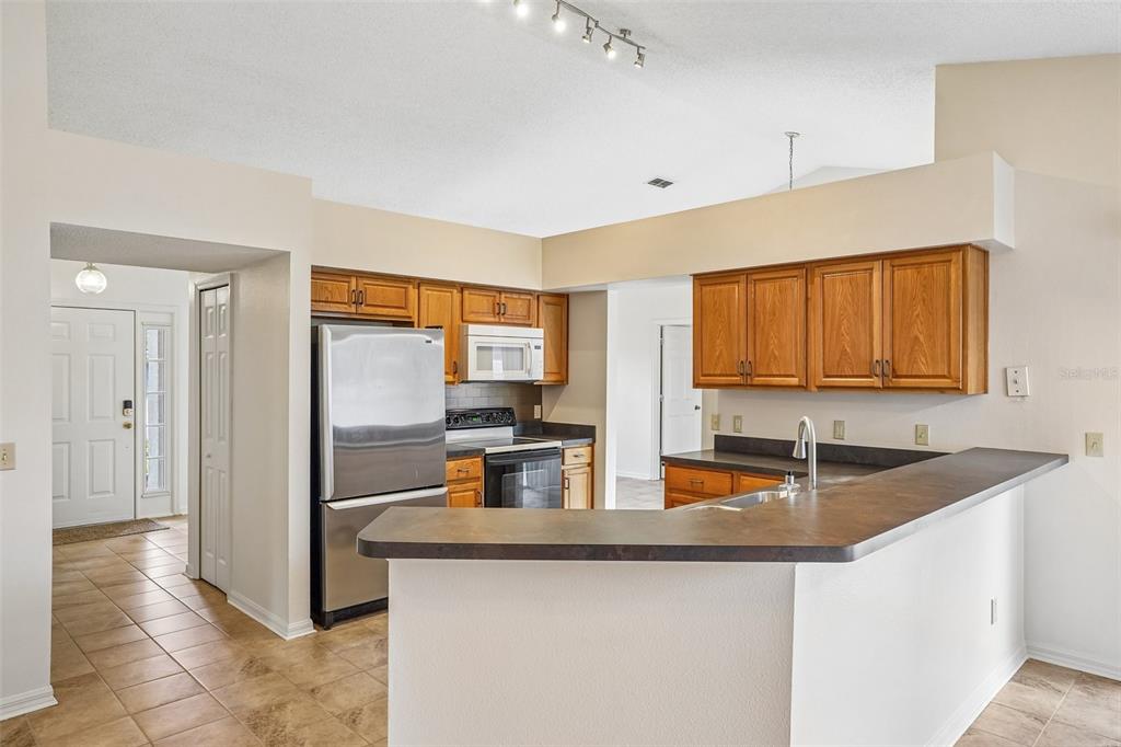 2596 Alclobe Circle Ocoee, FL 34761 - Photo 19 of 70 a kitchen with sink and refrigerator