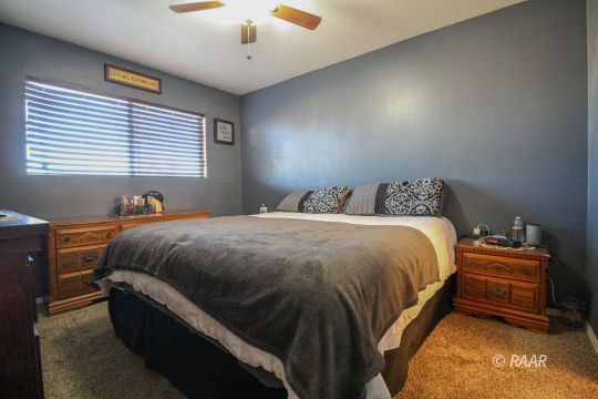 632 South Nevada Street Ridgecrest, CA 93555 - Photo 22 of 29 a bed sitting in a bedroom next to a window