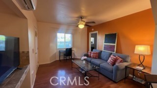 583 Calle Abronia South, Unit A Palm Springs, CA 92264 - Photo 11 of 19 a living room with furniture and a flat screen tv
