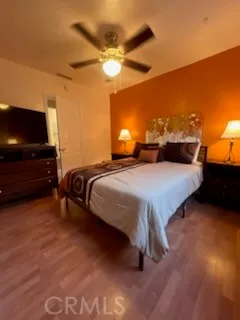 a spacious bedroom with a bed and a ceiling fan