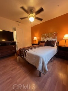 583 Calle Abronia South, Unit A Palm Springs, CA 92264 - Photo 15 of 19 a spacious bedroom with a bed and a ceiling fan