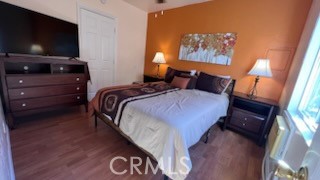 583 Calle Abronia South, Unit A Palm Springs, CA 92264 - Photo 16 of 19 a bedroom with a bed and a flat screen tv