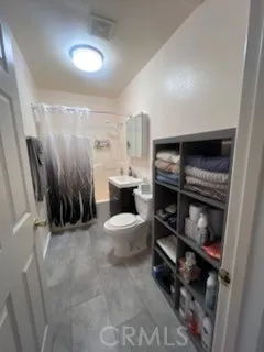 a bathroom with a sink a toilet and a shower