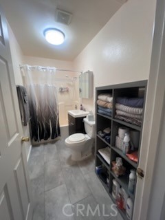 583 Calle Abronia South, Unit A Palm Springs, CA 92264 - Photo 17 of 19 a bathroom with a sink a toilet and a shower