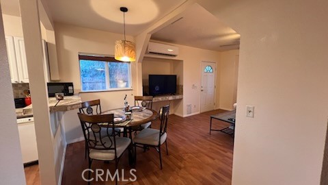 583 Calle Abronia South, Unit A Palm Springs, CA 92264 - Photo 5 of 19 a view of a dining room with furniture and a flat screen tv