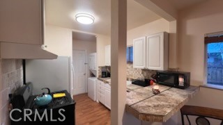 583 Calle Abronia South, Unit A Palm Springs, CA 92264 - Photo 7 of 19 a living room with furniture and wooden floor