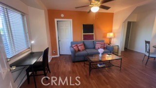 583 Calle Abronia South, Unit A Palm Springs, CA 92264 - Photo 10 of 19 a living room with furniture and a wooden floor