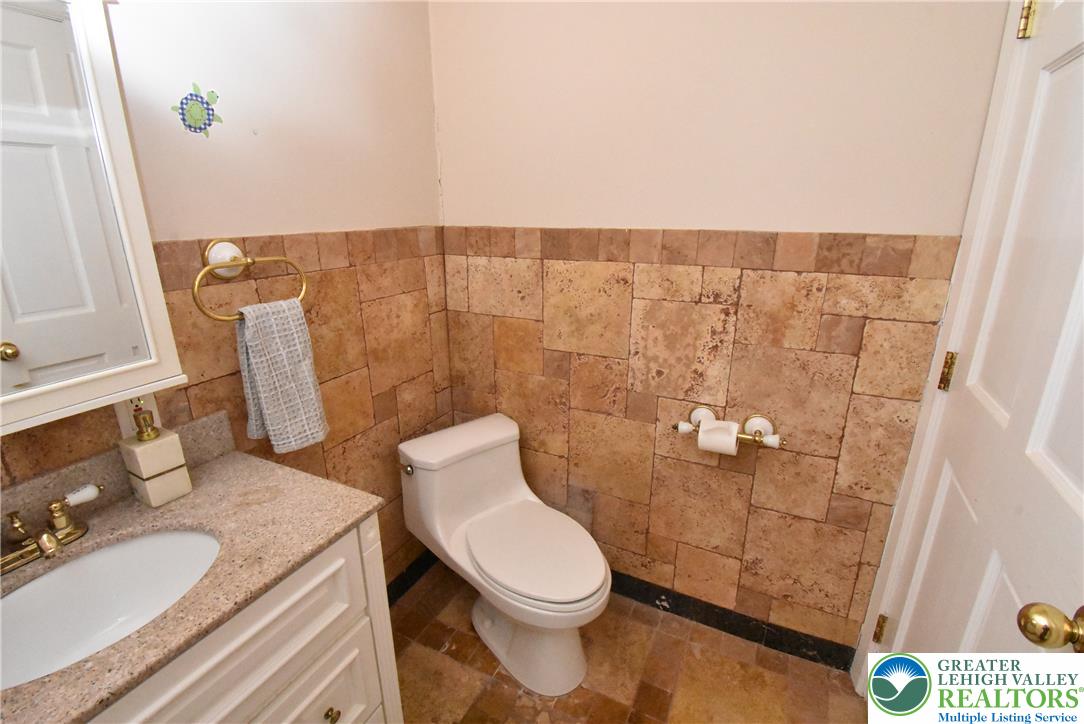 424 Grape Street Whitehall, PA 18052 - Photo 49 of 56 This bathroom features tile floors and walls, with a vanity and toilet.