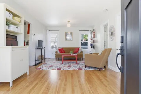 a living room with furniture and a rug