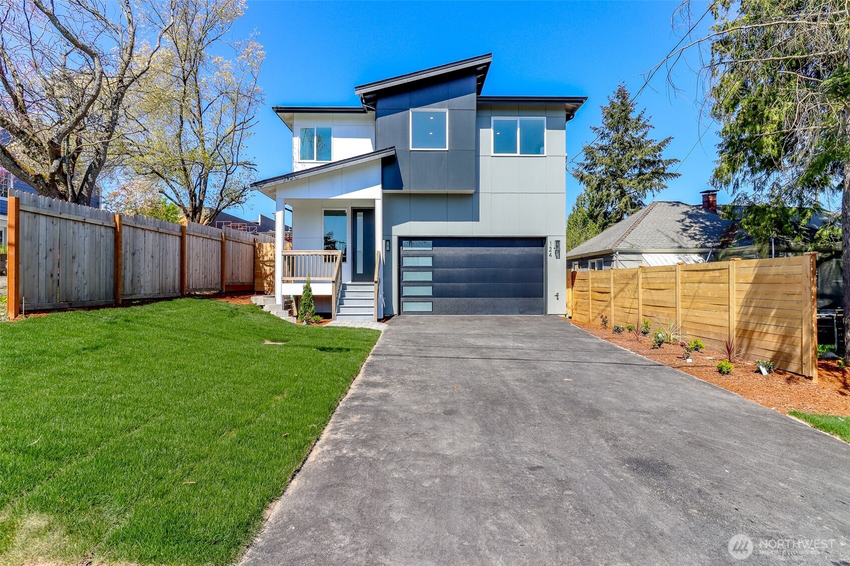 a front view of a house with a yard and garage