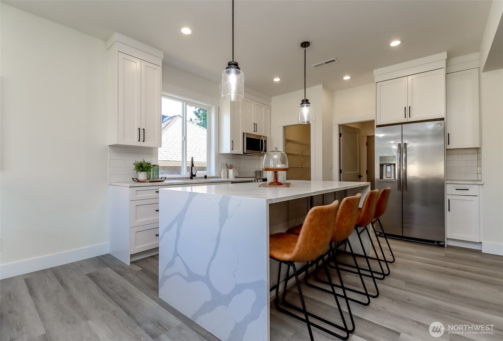 124 South 108th Place Seattle, WA 98168 - Photo 12 of 38 a kitchen with stainless steel appliances granite countertop a refrigerator a stove a sink dishwasher and white cabinets with wooden floor