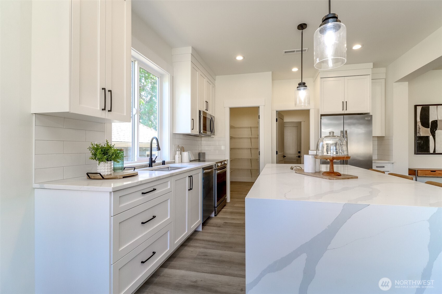 124 South 108th Place Seattle, WA 98168 - Photo 14 of 38 a large kitchen with kitchen island a sink stainless steel appliances and cabinets