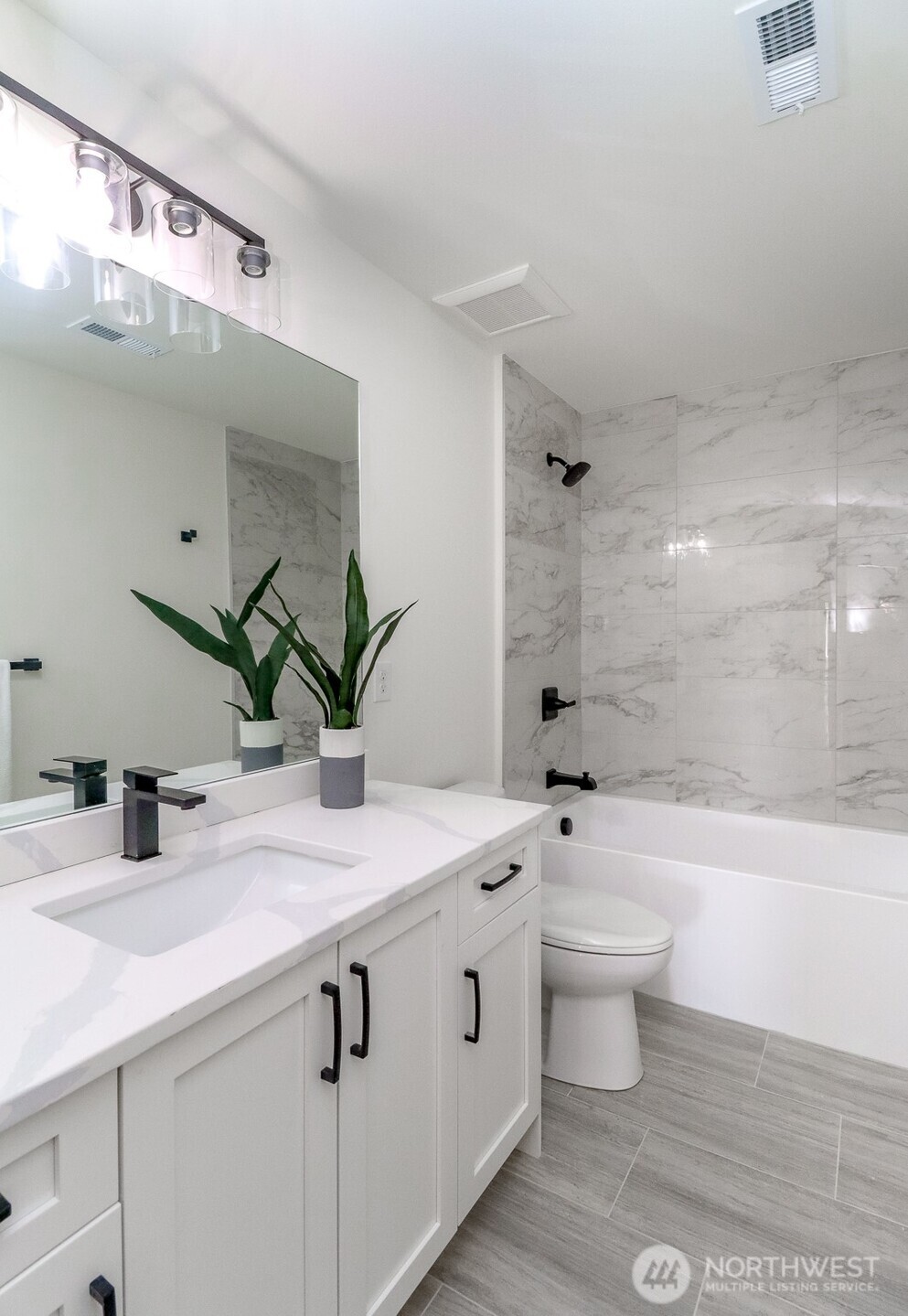 124 South 108th Place Seattle, WA 98168 - Photo 19 of 38 a bathroom with a double vanity sink toilet and shower