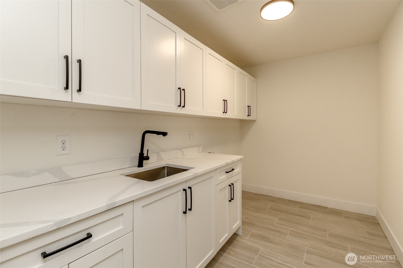 124 South 108th Place Seattle, WA 98168 - Photo 20 of 38 a kitchen with a sink and cabinets
