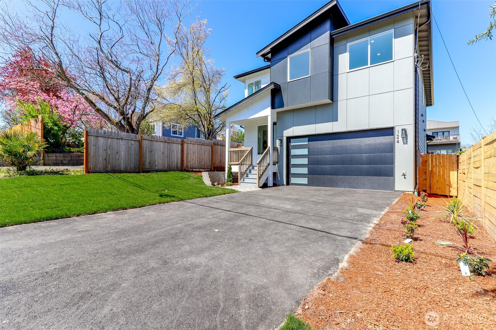 124 South 108th Place Seattle, WA 98168 - Photo 2 of 38 a front view of a house with a yard and garage