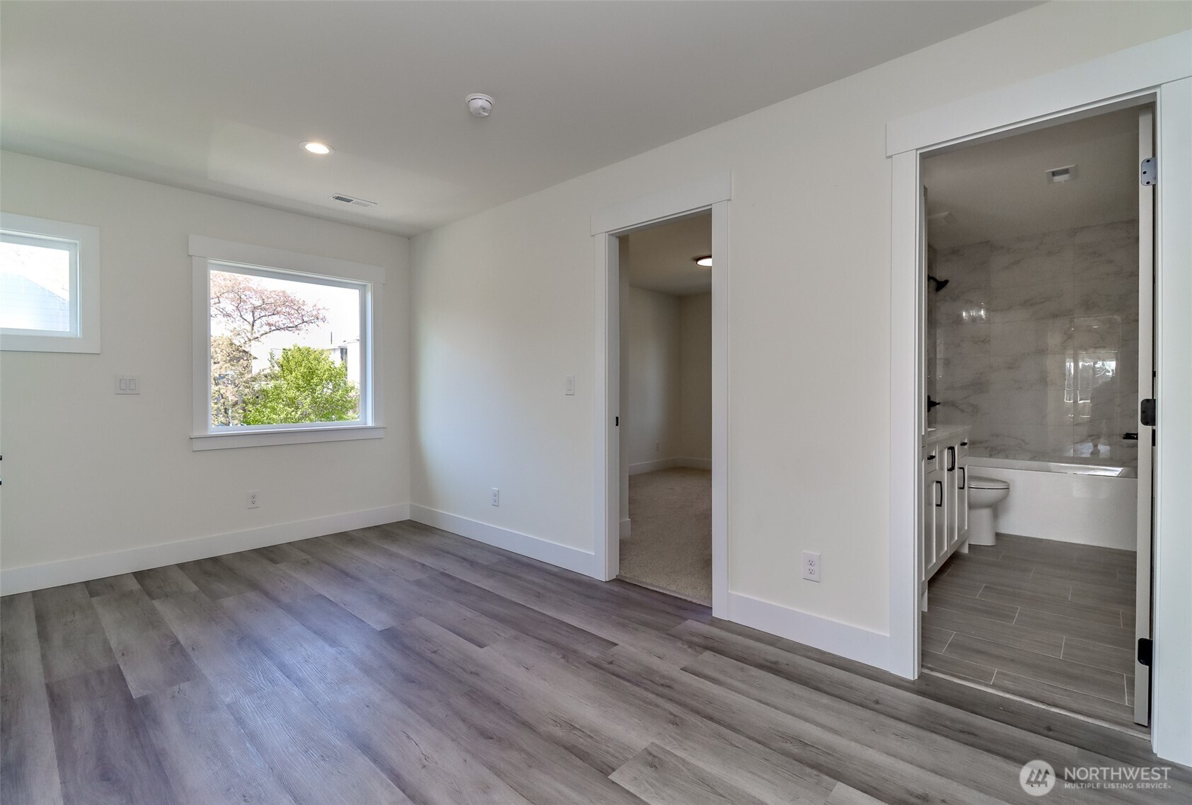 124 South 108th Place Seattle, WA 98168 - Photo 25 of 38 wooden floor in an empty room with a window