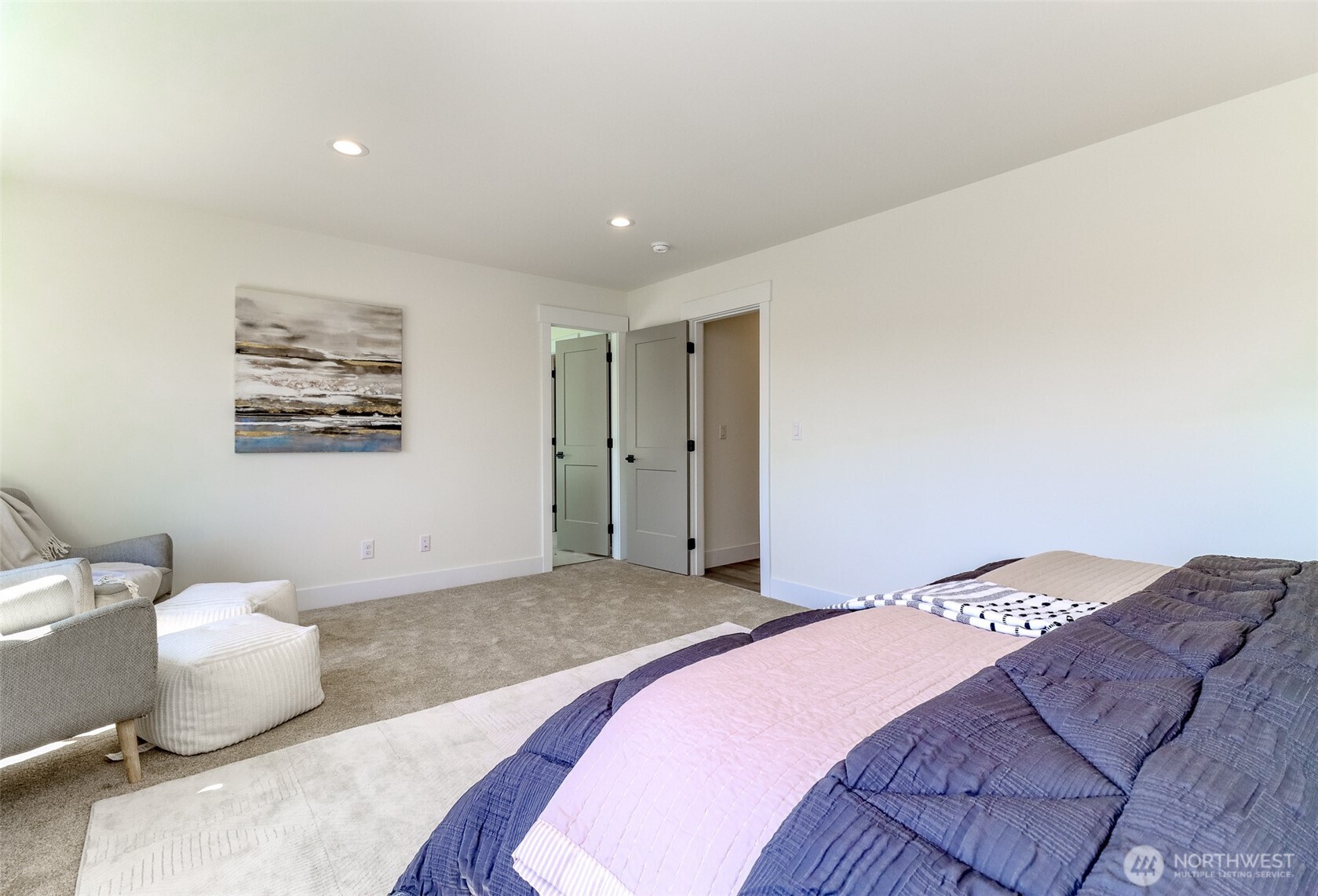 124 South 108th Place Seattle, WA 98168 - Photo 28 of 38 a bedroom with a large bed and a chandelier