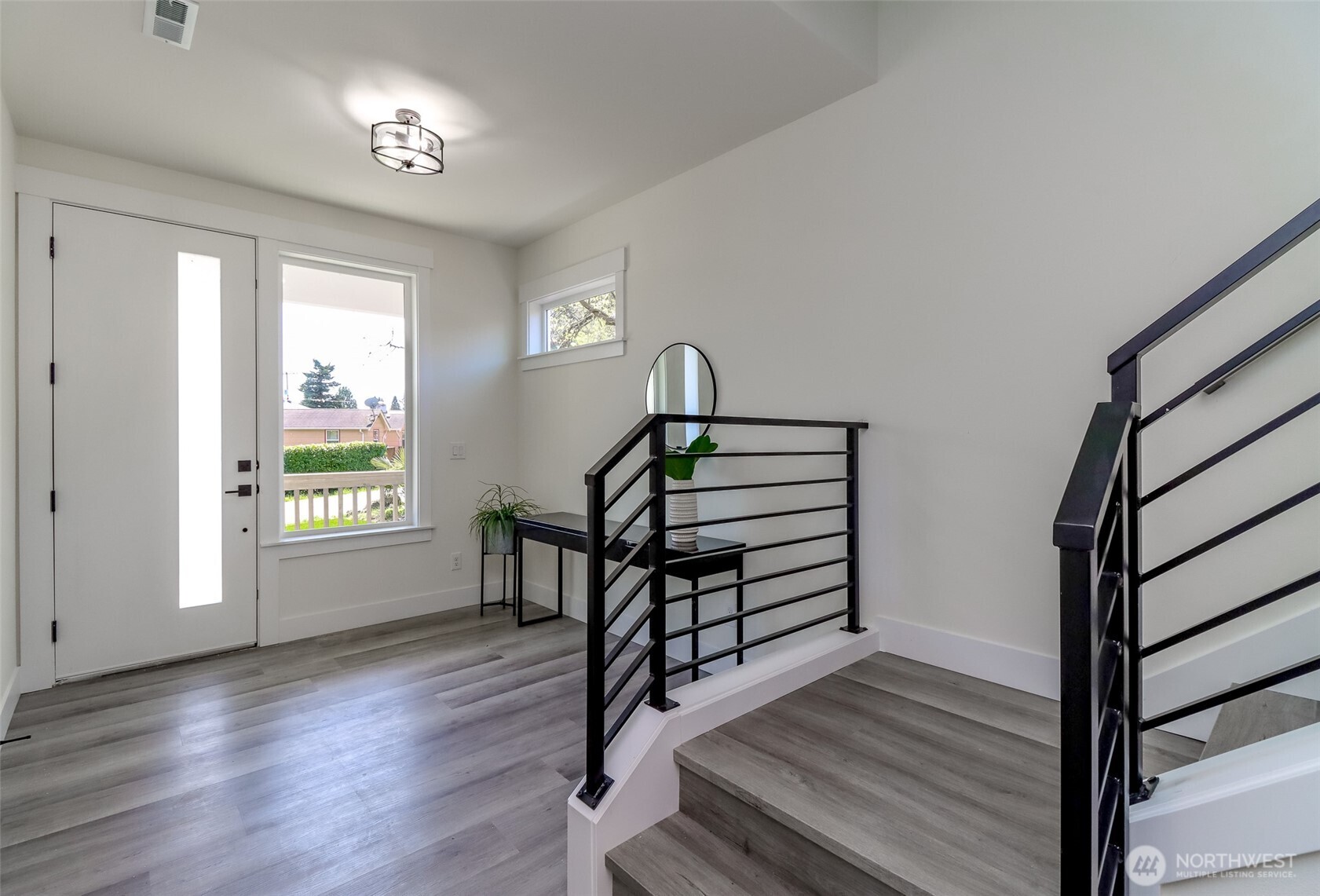 124 South 108th Place Seattle, WA 98168 - Photo 4 of 38 a view of entryway with wooden floor and window