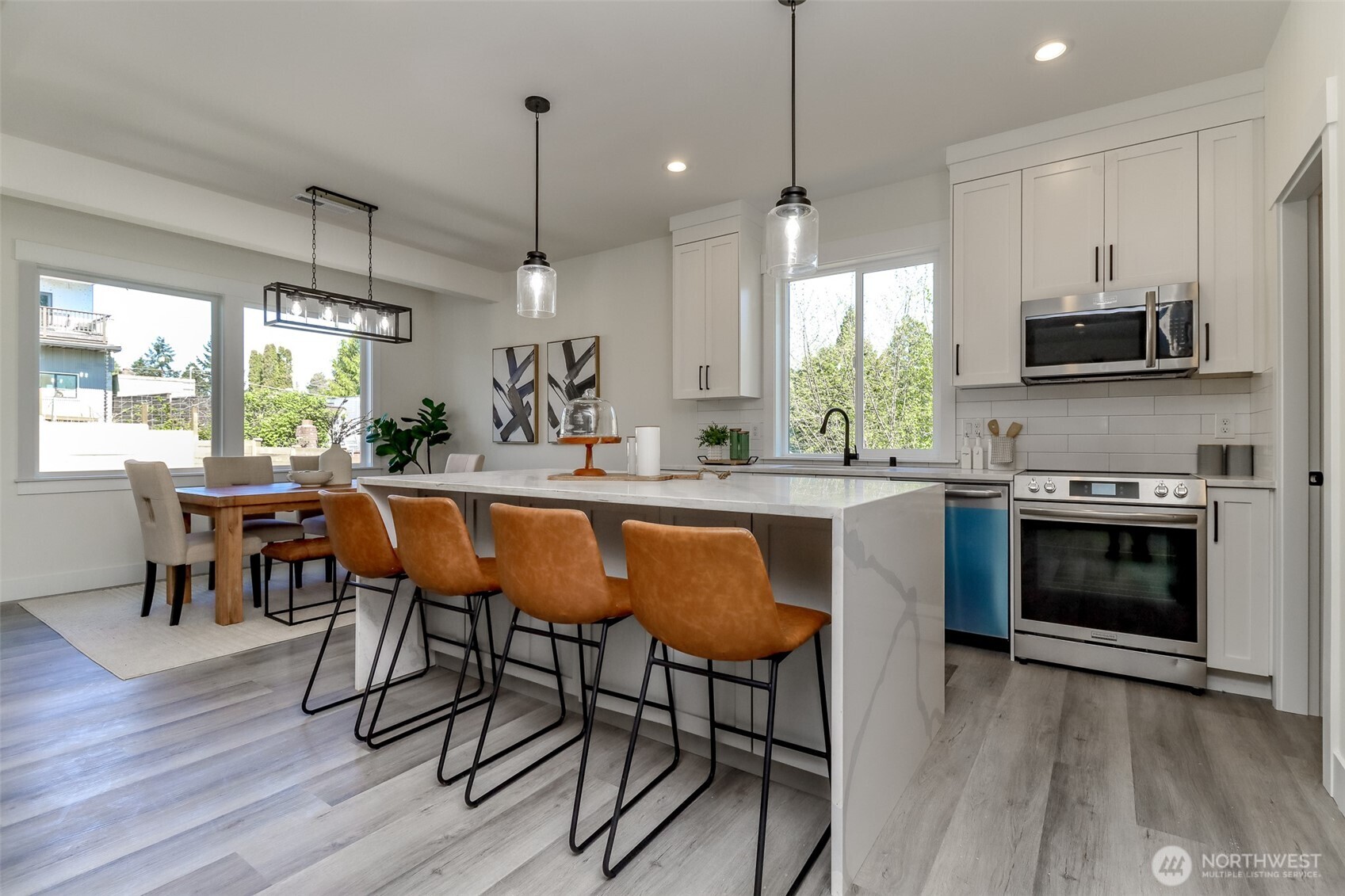 124 South 108th Place Seattle, WA 98168 - Photo 10 of 38 a kitchen with kitchen island granite countertop a sink a counter space appliances and a window
