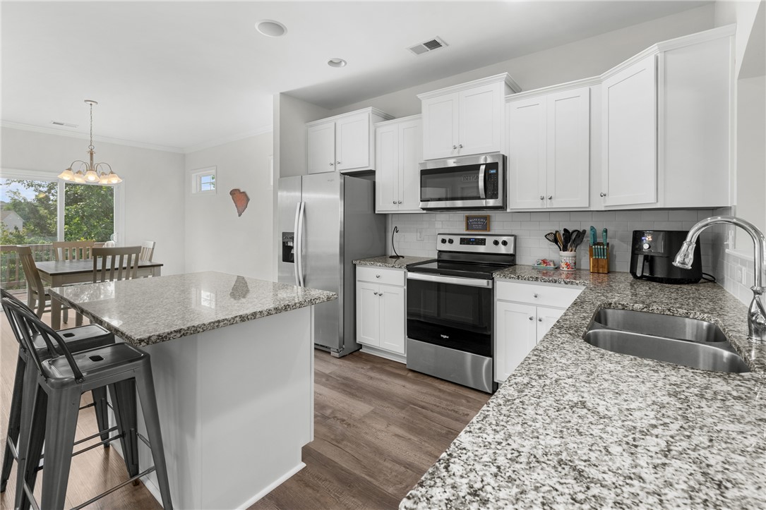 768 Rocky Ridge Circle Seneca, SC 29678 - Photo 12 of 30 Prepare meals with ease in this well-appointed kitchen featuring a functional island and gleaming stainless steel appliances.