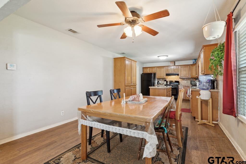 301 Bascom Road Whitehouse, TX 75791 - Photo 14 of 31 a view of a dining room with furniture and a chandelier fan