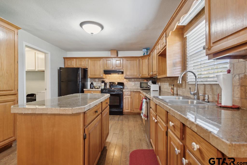 301 Bascom Road Whitehouse, TX 75791 - Photo 17 of 31 a kitchen with stainless steel appliances granite countertop a sink stove and refrigerator