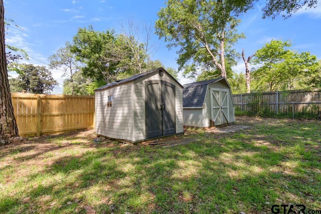 301 Bascom Road Whitehouse, TX 75791 - Photo 25 of 31 a view of backyard with large tree and wooden fence