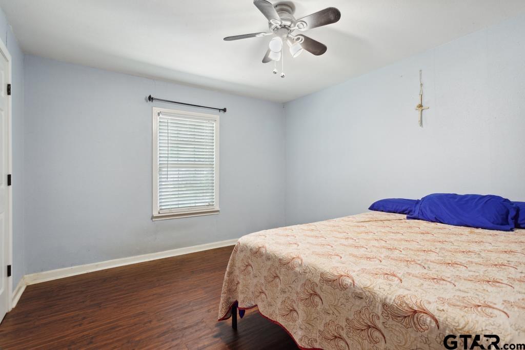 301 Bascom Road Whitehouse, TX 75791 - Photo 6 of 31 a bedroom with a bed and wooden floor