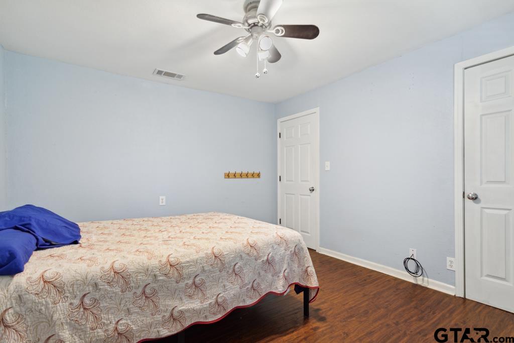 301 Bascom Road Whitehouse, TX 75791 - Photo 7 of 31 a bedroom with a bed and wooden floor