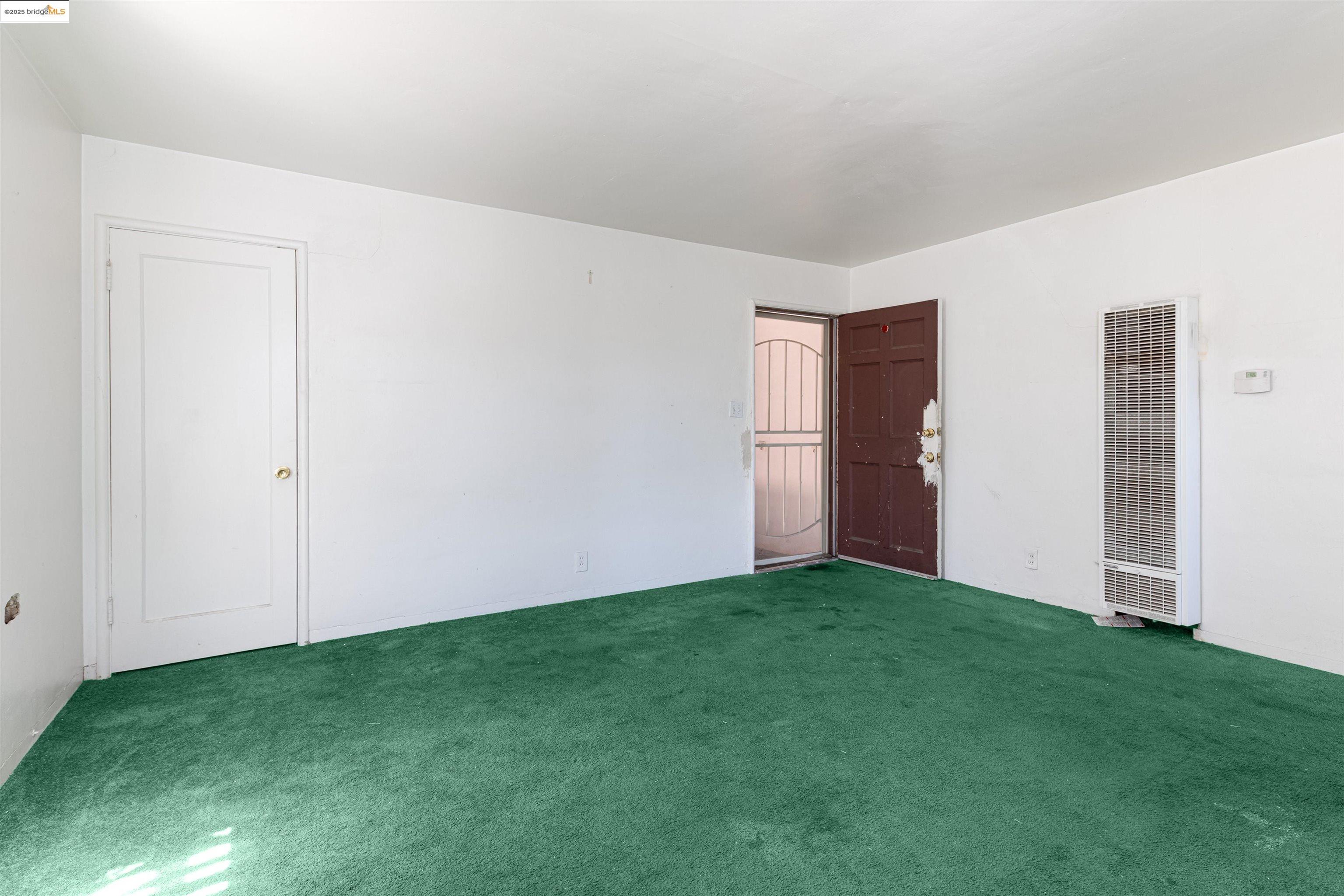 1427 65th Avenue Oakland, CA 94621 - Photo 2 of 13 a view of an empty room with closet and entryway