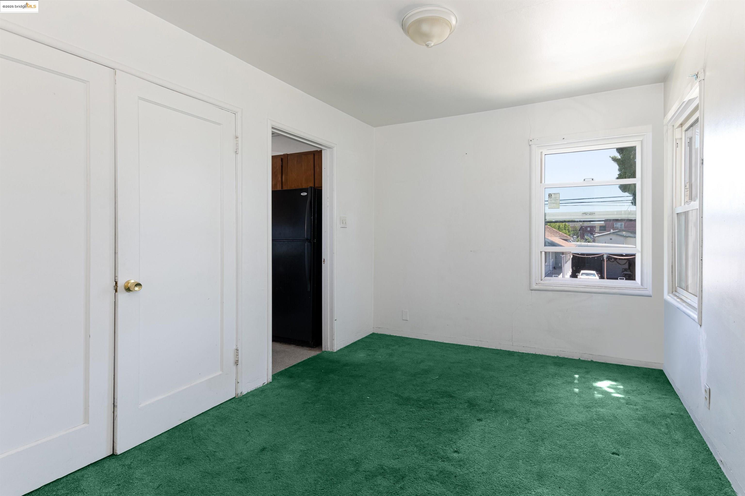 1427 65th Avenue Oakland, CA 94621 - Photo 5 of 13 a view of an empty room with window and closet area