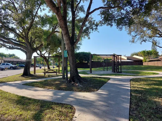 a view of a park with large trees