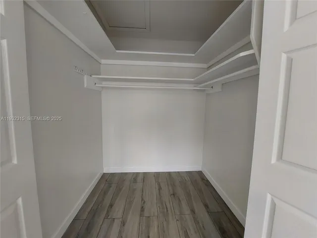 a view of a room with wooden floor