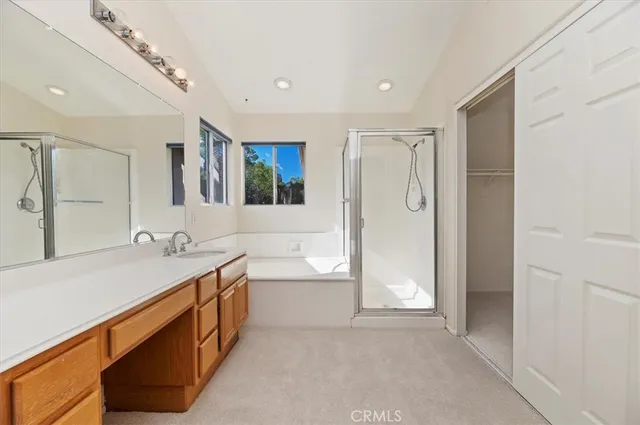 a bathroom with a tub sink and mirror