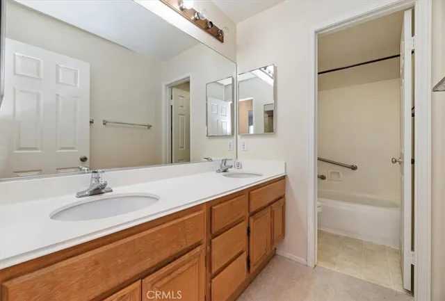 a bathroom with a double vanity sink mirror and double