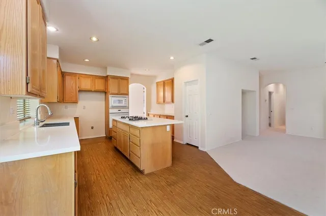 a kitchen with a sink stove and cabinets