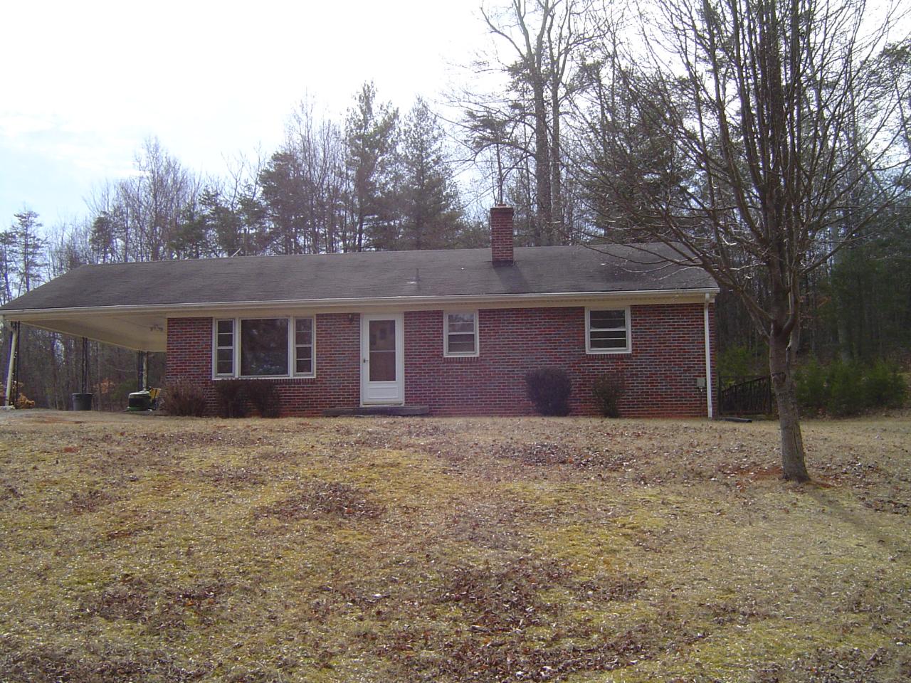 a house that has a tree in front of it