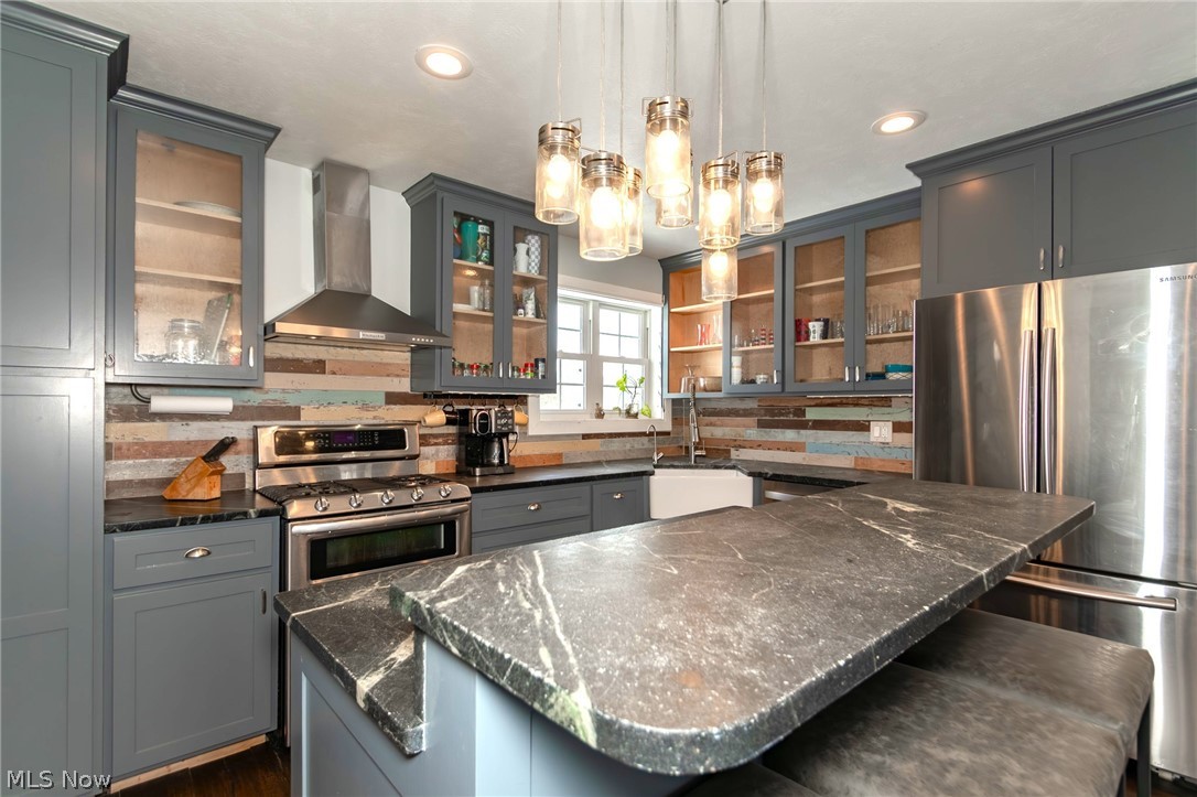 18919 Ravenna Road Chagrin Falls, OH 44023 - Photo 7 of 48 Custom cabinetry, solid surface counters, stainless appliances and a great island with a informal dining counter