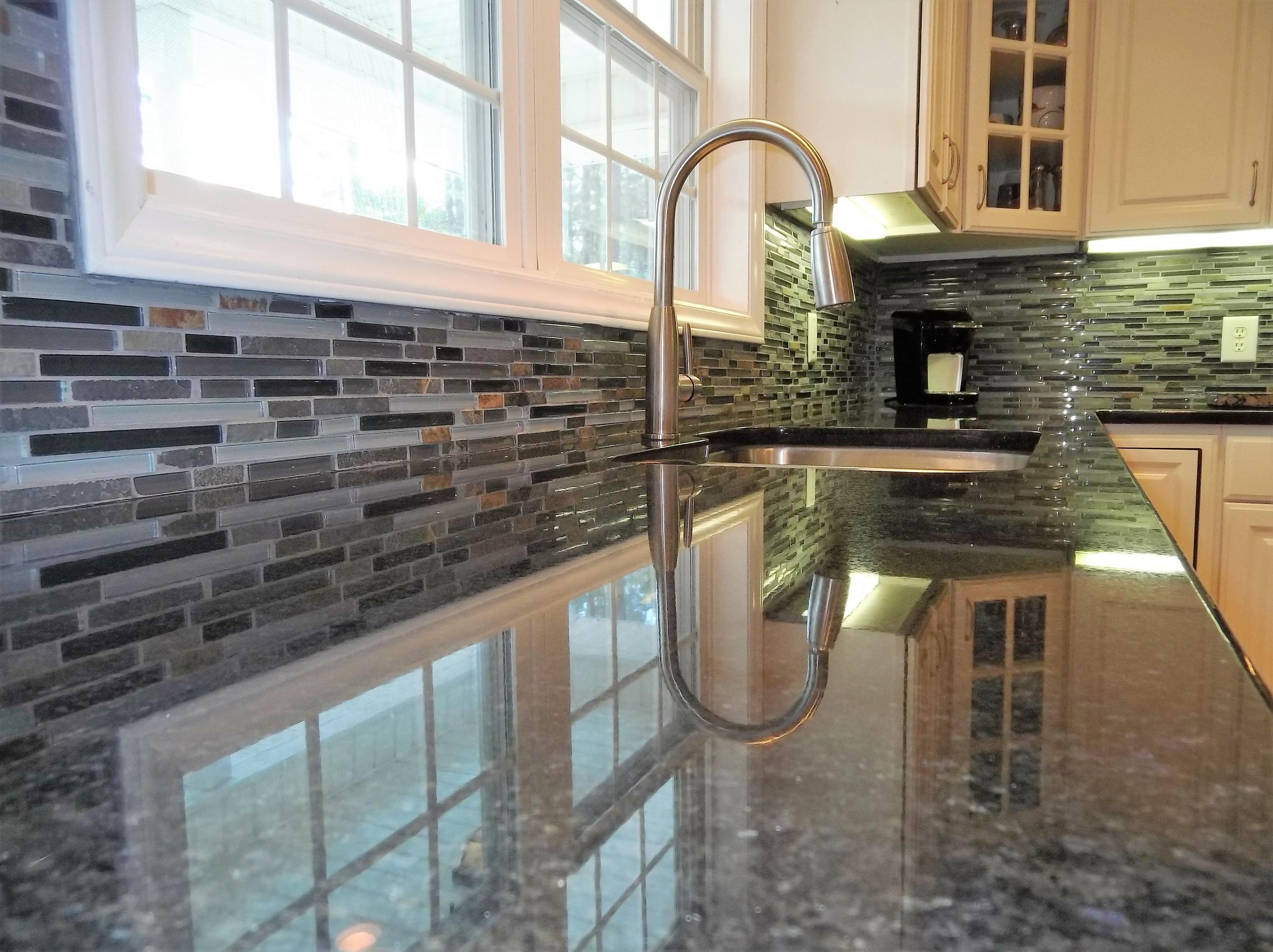 229 B Foxfire Road Aberdeen, NC 28315 - Photo 11 of 47 Beautiful granite countertops and a mosaic tile backsplash.