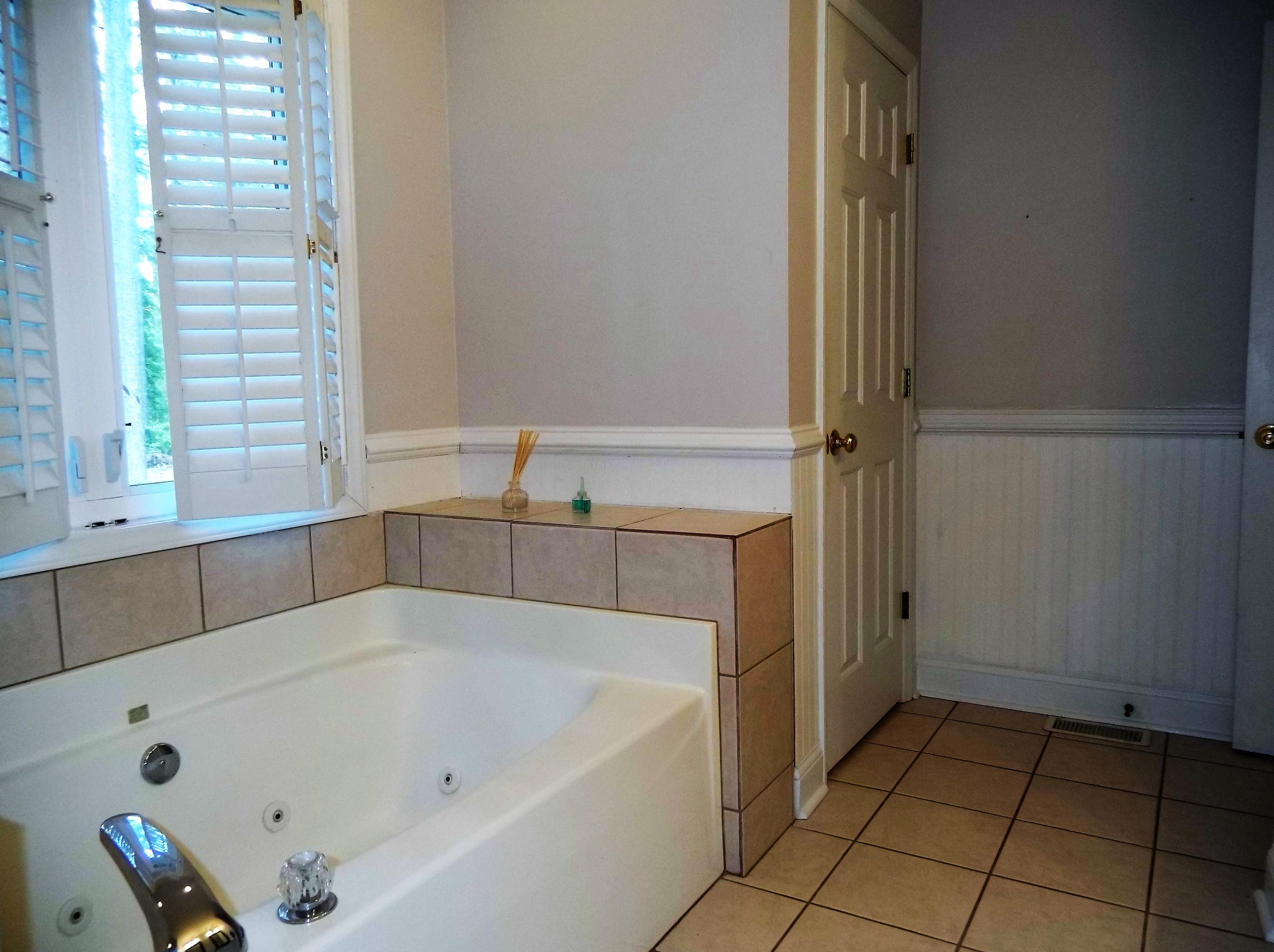 229 B Foxfire Road Aberdeen, NC 28315 - Photo 24 of 47 Jetted tub with white shutters for privacy still allow natural daylight to filter in.