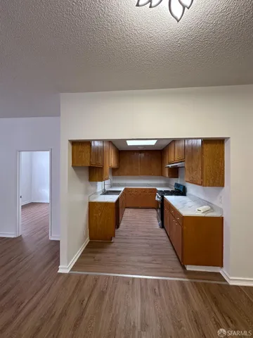 a kitchen with stainless steel appliances granite countertop a stove a sink and a refrigerator