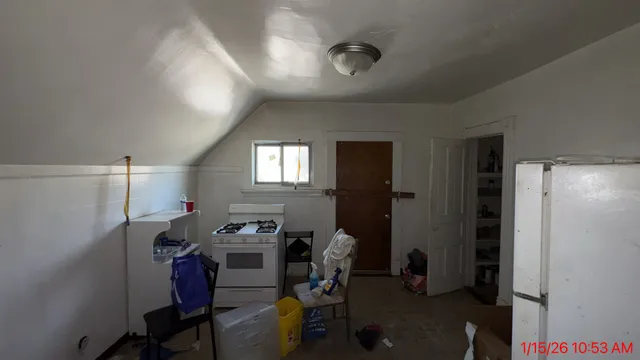 a room with furniture a mirror and a wooden floor