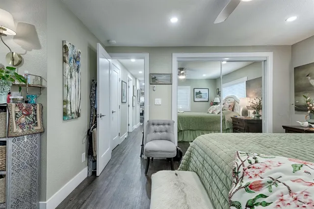 a bedroom with a bed and a view of living room