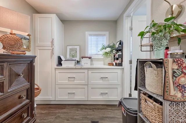 a bathroom with a sink a mirror and a potted plant