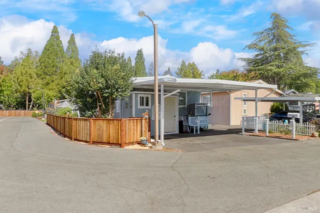 a view of a house with backyard and sitting area