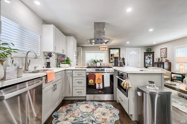 a kitchen with a sink stove and cabinets