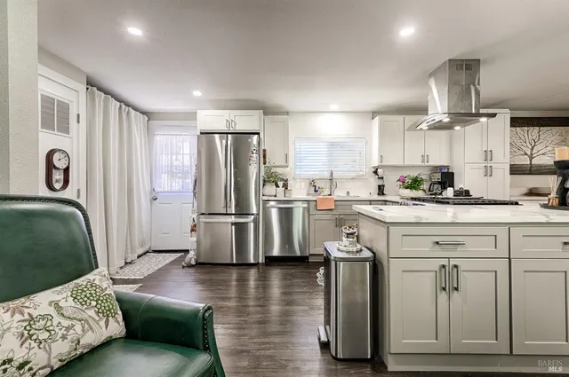 a kitchen with stainless steel appliances granite countertop a refrigerator sink and cabinets
