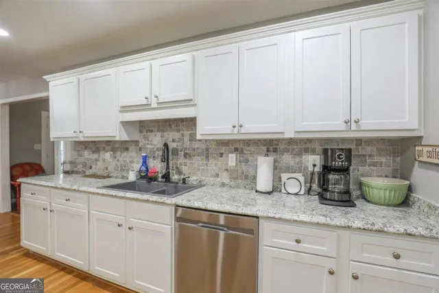 a kitchen with lots of counter space and appliances